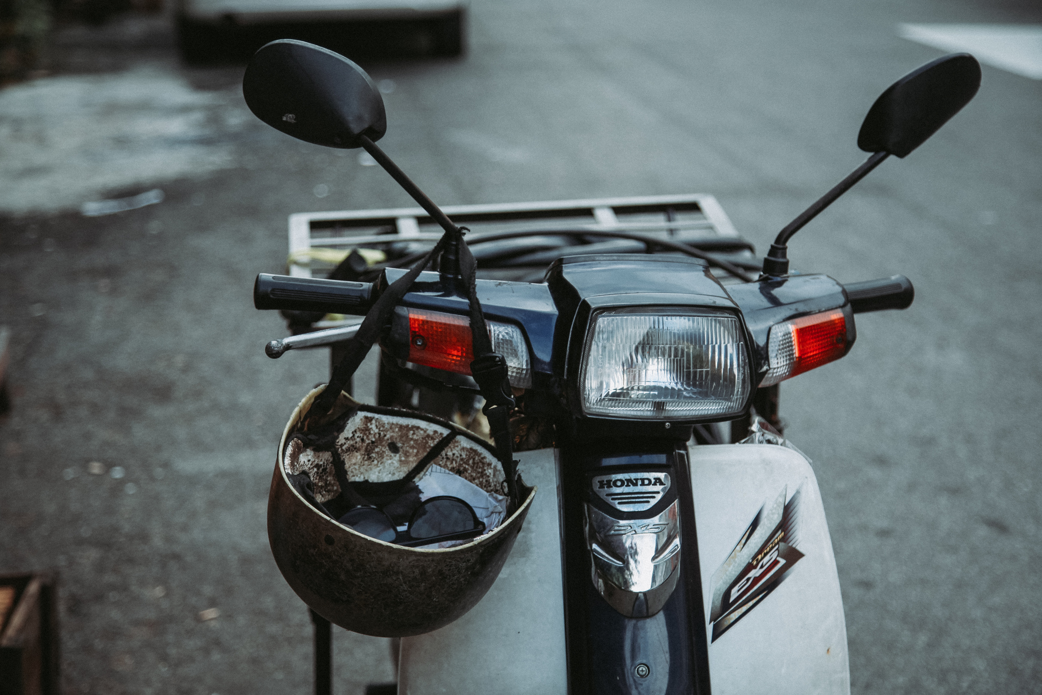Retro motorbike with helmet on street